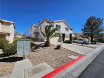 Charming two-story home featuring desert landscaping, a two-car garage, and a sunny curb appeal at 780 Spotted Eagle St, Henderson, NV 89015