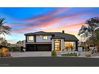 Stunning two-story home featuring a modern design, manicured landscaping, and a three-car garage at 8717 Kingship Ct, Las Vegas, NV 89129