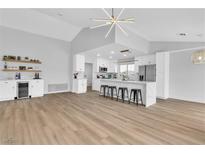 Bright kitchen with stainless steel appliances, white cabinets, and modern light fixture at 8812 Stoney Point Dr, Las Vegas, NV 89134