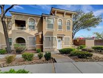 Inviting townhome with manicured landscaping, arched entry, and stylish architectural details at 10001 Peace Way # 1321, Las Vegas, NV 89147