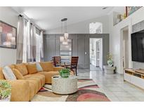 Bright living room featuring a comfortable sectional couch, modern lighting, and stylish decor at 139 Serenade Ct, Henderson, NV 89074