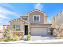 Charming two-story home with a well-manicured lawn and a two-car garage at 2604 Iron Crest Ln, Las Vegas, NV 89138