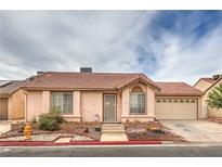 Charming single-story home featuring a red tile roof and a well-maintained, low-water landscaping design at 2735 Poppyseed Way, Las Vegas, NV 89142