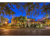 Stunning two-story home with lush landscaping and circular driveway at twilight at 2994 San Lorenzo Ct, Henderson, NV 89052