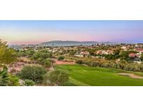 Scenic view of a lush golf course with city and mountain views, offering a serene and picturesque setting at 2994 San Lorenzo Ct, Henderson, NV 89052
