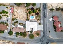 Expansive aerial view of a property with a pool, lush landscaping, and desert surroundings at 3101 Margarita St, Pahrump, NV 89048