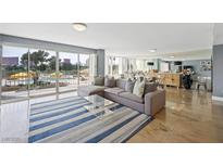 Bright living room with large windows offering pool views and comfortable modern furnishings at 3111 Bel Air Dr # 3C, Las Vegas, NV 89109