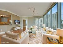 Bright living room featuring a fluffy rug, floor-to-ceiling windows, and contemporary furnishings at 322 Karen Ave # 708, Las Vegas, NV 89109