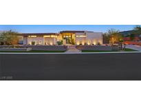 Striking modern home with manicured landscaping, illuminated stairs and attractive exterior lighting features at 49 Crested Cloud Way, Las Vegas, NV 89135