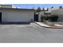 Charming single-story home featuring a two-car garage, desert landscaping, and a gated entrance at 774 Anne Ln, Henderson, NV 89015