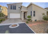 Contemporary two-story home boasts a two-car garage, desert landscaping, and neutral exterior paint at 816 Stannard Ct, Henderson, NV 89052