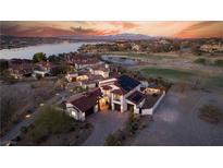 Breathtaking aerial view of a luxurious home with a red tile roof, pool, and stunning sunset views at 18 Grand Corniche Dr, Henderson, NV 89011