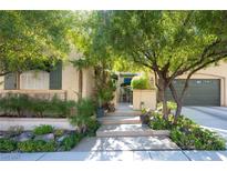 Charming home featuring mature landscaping and a welcoming entrance with gated courtyard and two car garage at 2279 Pacini Ct, Henderson, NV 89052