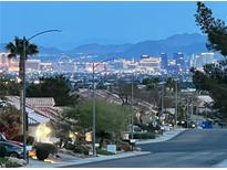 Night view of the Las Vegas strip and skyline over a residential neighborhood at 2736 Darby Falls Dr, Las Vegas, NV 89134