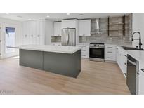 Bright kitchen featuring stainless steel appliances, a large island, and white cabinetry, ideal for cooking and entertaining at 2894 Matese Dr, Henderson, NV 89052