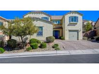 Charming two-story home featuring desert landscaping, a brick driveway, and blue shutters at 352 Sidewheeler St, Henderson, NV 89012