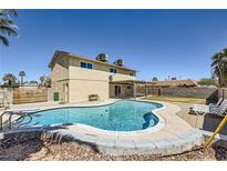 Backyard featuring a large in-ground pool, lounge chairs, and a covered patio area, perfect for outdoor relaxation and entertainment at 3577 Wayne Cir, Las Vegas, NV 89121