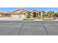 Beige single-story home with three-car garage and desert landscaping, offering curb appeal at 3662 Riley Ann Ave, Las Vegas, NV 89139