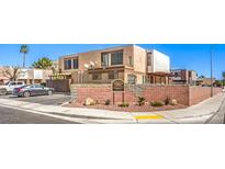 A welcoming exterior view of a multi-Gathering building with desert landscaping and community signage at 3683 Villa Knolls East Dr, Las Vegas, NV 89120