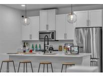 Modern kitchen featuring white cabinets, stainless steel appliances, and pendant lighting at 600 N Carriage Hill Dr # 1164, Las Vegas, NV 89138