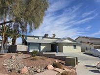 Charming single-story home featuring desert landscaping, mature trees, and an inviting front entryway at 6710 Redwood Cir, Las Vegas, NV 89103