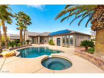 Backyard pool with spa and palm trees provides a relaxing outdoor oasis at 8925 Silent Brook Ct, Las Vegas, NV 89149
