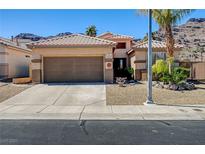 Charming single-story home featuring a desert landscape, tile roof and a two-car garage at 97 Zimmerman St, Henderson, NV 89002