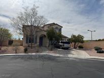 Two-story stucco home featuring arched entry and driveway at 11769 Via Vera Cruz Ct, Las Vegas, NV 89138