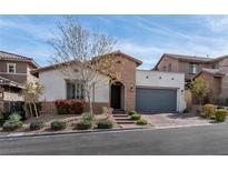 Charming single-story home featuring a well-manicured front yard and a two-car garage at 11843 Cogoleto Ave, Las Vegas, NV 89138