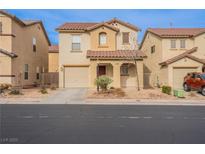 Inviting two-story home featuring a terracotta roof, desert landscaping, and an attached one car garage at 11943 Jersey Lilly St, Las Vegas, NV 89183