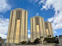 Three high rise buildings with golden glass windows and blue sky at 125 E Harmon Ave # 1003, Las Vegas, NV 89109