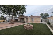 Charming home featuring a well-maintained front yard and a lovely decorative fire pit at 1910 Hoover St, North Las Vegas, NV 89030