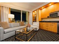 Comfortable living room area featuring a gray couch, armchair, and city views at 2000 Fashion Show Dr # 2604, Las Vegas, NV 89109