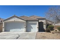 Charming single-story home featuring a three-car garage and well-kept landscaping at 3433 Nebaum Ct, North Las Vegas, NV 89032