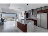 Modern kitchen boasts stainless appliances, an island, and stunning city views at 4471 Dean Martin Dr # 1202, Las Vegas, NV 89103