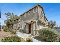 Charming two-story townhome with stucco exterior, covered entryway, and well-maintained landscaping at 470 Dorchester Bend Ave # 3, North Las Vegas, NV 89032