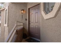 Inviting front entry featuring a brown door, textured stucco exterior, and clear unit number at 5040 S Rainbow Blvd # 201, Las Vegas, NV 89118