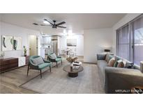 Bright living room with a ceiling fan, modern furniture, and an open floor plan at 5101 Village Dr, Las Vegas, NV 89142