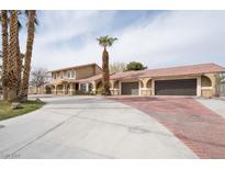 Spacious home features a well manicured yard, mature palm trees, and a large driveway for ample parking at 6130 Tara Ave, Las Vegas, NV 89146
