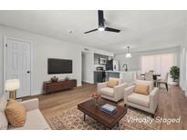 Bright, staged living room boasts a ceiling fan and updated decor at 728 Carpenter Dr, Las Vegas, NV 89107