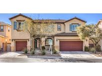Inviting two-story home with desert landscaping, two-car garage and a tile roof on a sunny day at 7709 Tiny Tortoise St, Las Vegas, NV 89149