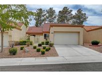 Exterior of single-Gathering home with a two car garage, a manicured lawn and desert landscaping at 8657 Prairie Hill Dr, Las Vegas, NV 89134