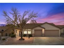 Charming single-story home with a well-maintained front yard and a spacious two-car garage at 1077 Las Palmas Entrada Ave, Henderson, NV 89012