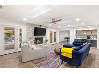 Bright living room with stone fireplace, recessed lighting, and stylish furnishings at 1625 Santa Anita Dr, Las Vegas, NV 89119