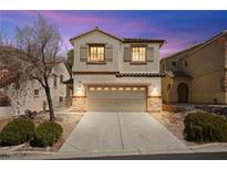 Charming two-story home featuring neutral tones and a welcoming two-car garage at 1640 Orange Daisy Pl, Henderson, NV 89012