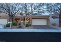 Charming single-story home featuring a two-car garage and mature landscaping at 2508 Palmridge Dr, Las Vegas, NV 89134