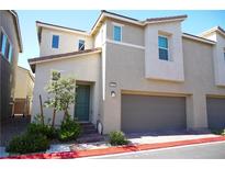 Charming two-story home with a two-car garage, xeriscape landscaping, and light-colored facade at 2765 Frosted Teal Ave, North Las Vegas, NV 89086