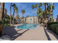 Enjoy the community pool area with beautiful palm trees, lounge seating, and well maintained landscaping at 3145 E Flamingo Rd # 2039, Las Vegas, NV 89121