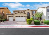 Inviting two-story home featuring a three-car garage and manicured landscaping at 3728 White Lion Ln, North Las Vegas, NV 89084