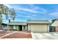 Charming single-story home featuring a two-car garage, green trim, and low-maintenance desert landscaping at 6791 Greengrove Dr, Las Vegas, NV 89103